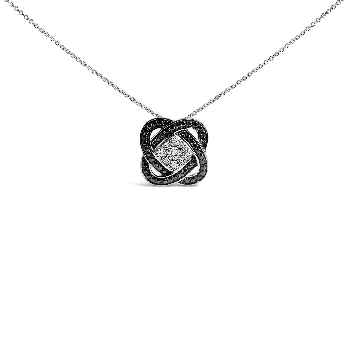 Front-facing shot of a white and black metal necklace with an interwoven knot-shaped pendant set with pave black gemstones and a cluster of invisible-set white gemstones in the center.