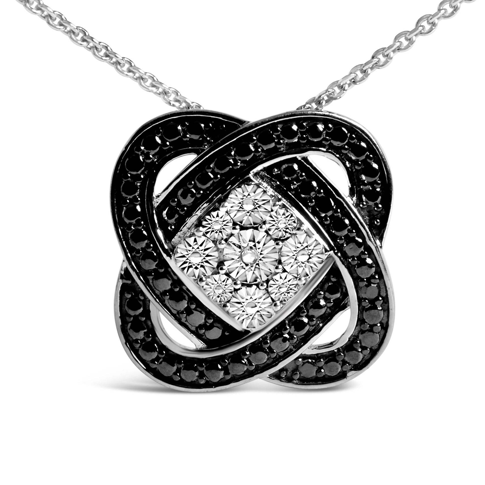 Front angle close-up of a white and black metal necklace pendant with an intricate knot design, featuring a central cluster of round white gemstones in an invisible setting surrounded by looping black pave-set round gemstones.