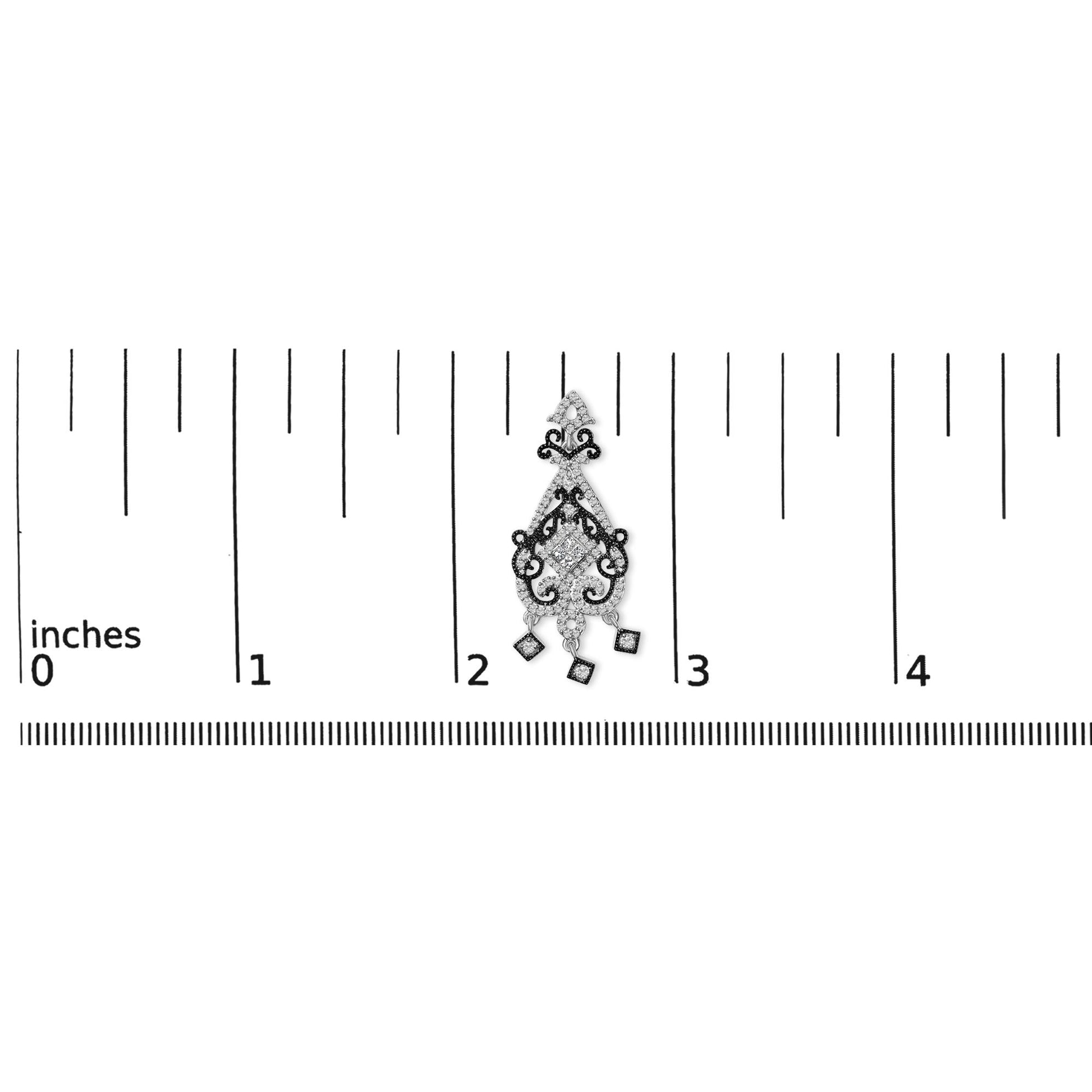 Earring with intricate white and black metal scrollwork, featuring square and round white gemstones, shown on a ruler for scale from a top-down angle.