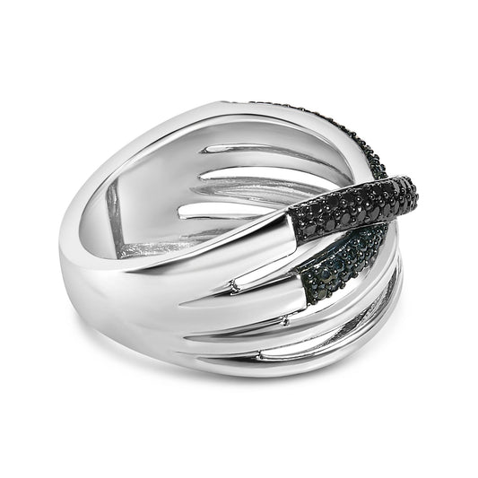 Close-up front angle of a white and black metal ring with overlapping bands, adorned with round black and blue gemstones in prong settings.