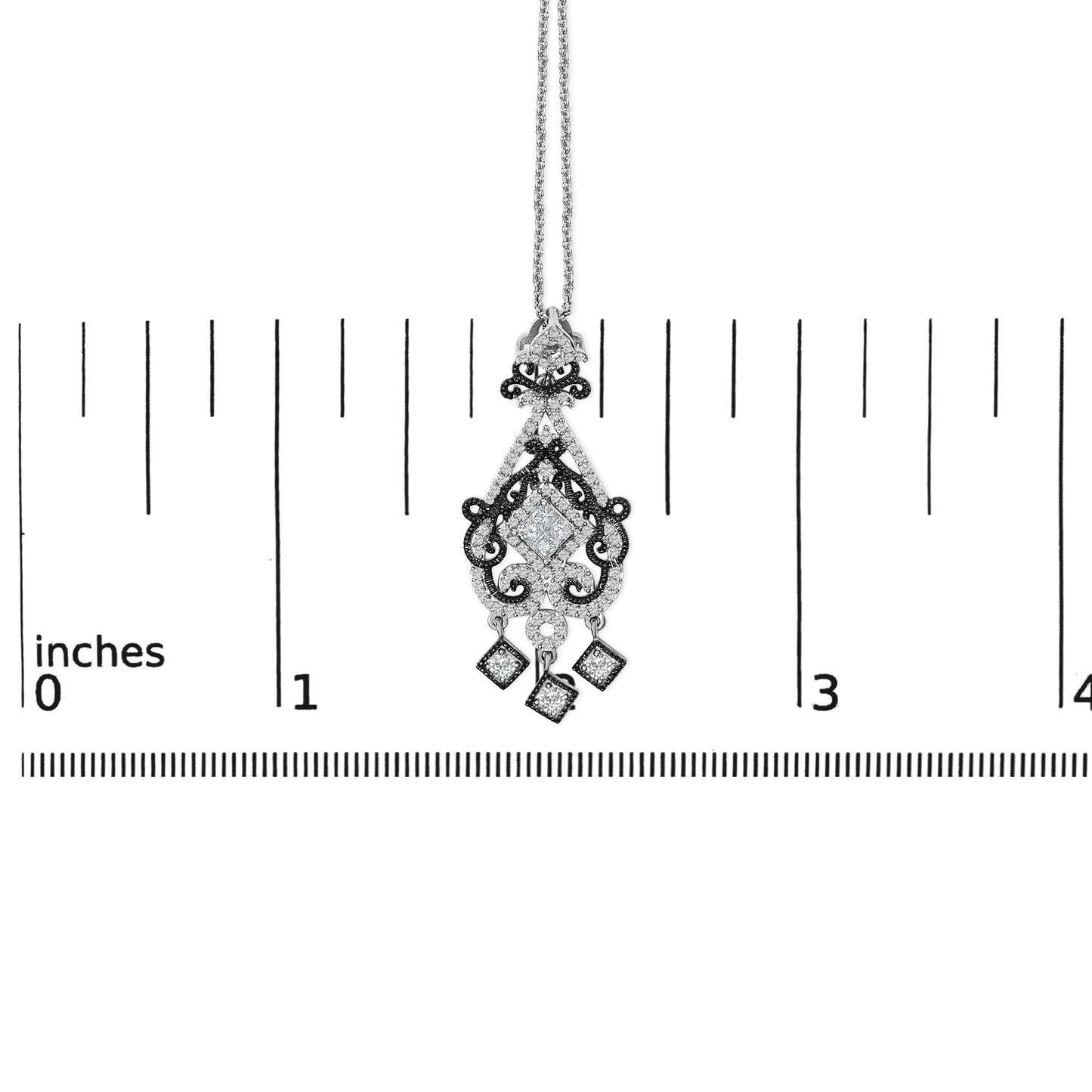 Necklace pendant in white and black metal with decorative scrollwork, white gemstones in princess and round shapes, and three dangle square charms, shown hanging on a ruler scale, front view.