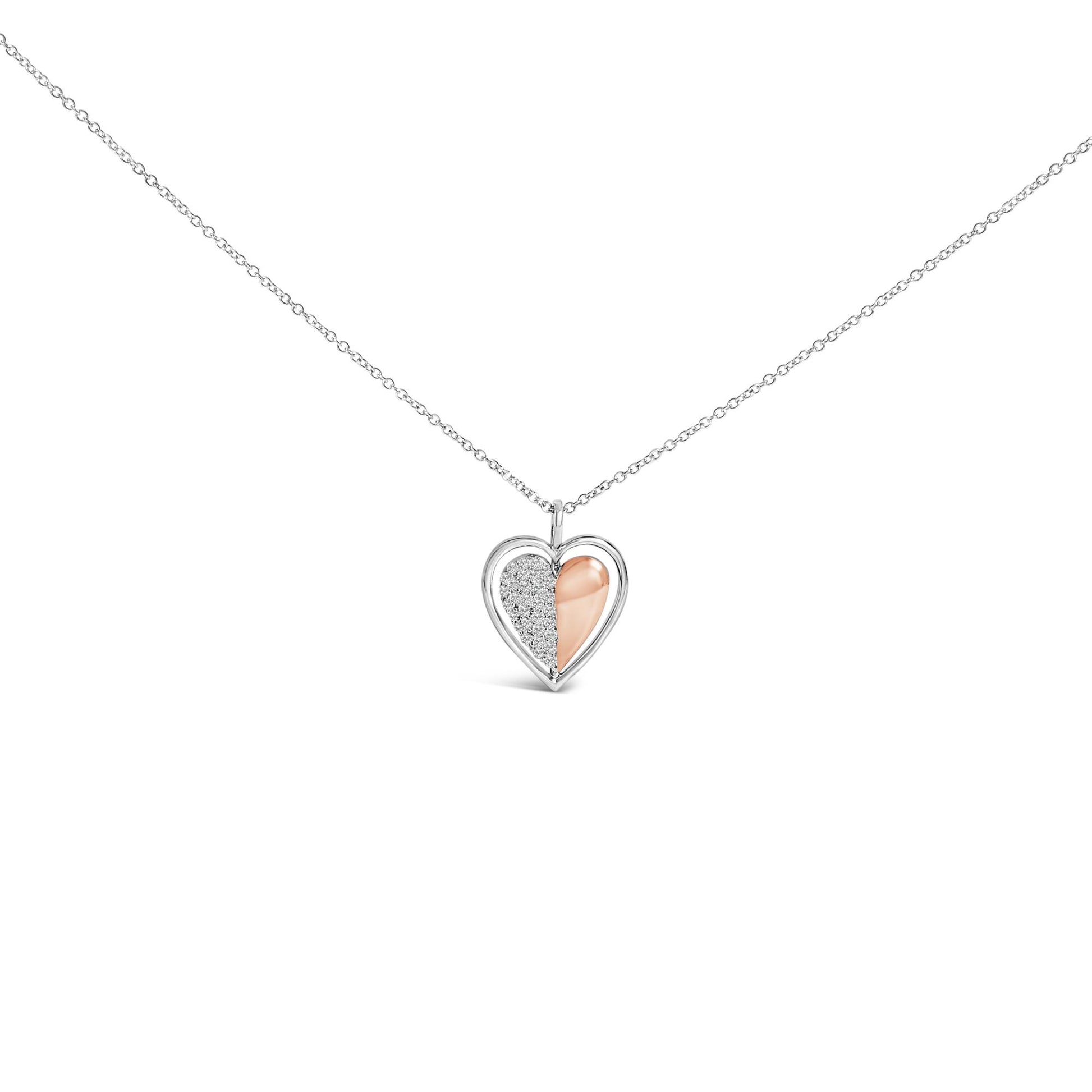 Close-up front view of a heart-shaped necklace pendant with one half featuring white gemstones in prong settings and the other half in a smooth rose-colored finish, hanging on a white-colored chain.