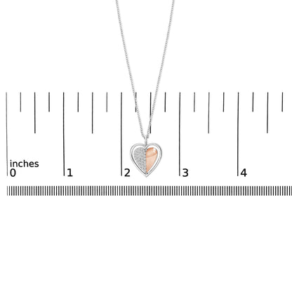 Front view of a heart-shaped necklace pendant with half white metal and white gemstones, and half rose metal, shown on a scale.