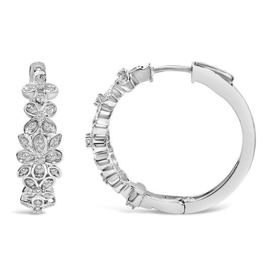 Close-up front and side views of white metal hoop earrings with floral designs featuring round white gemstones in pave setting.