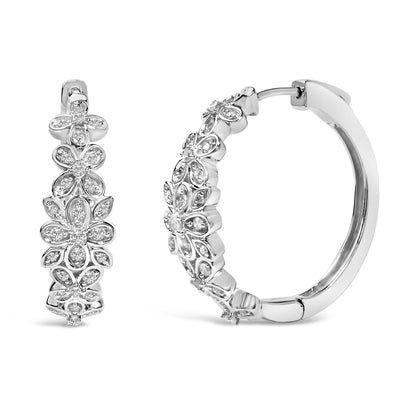 Close-up front and side view of white metal hoop earrings with floral designs set with round white gemstones in pave setting.