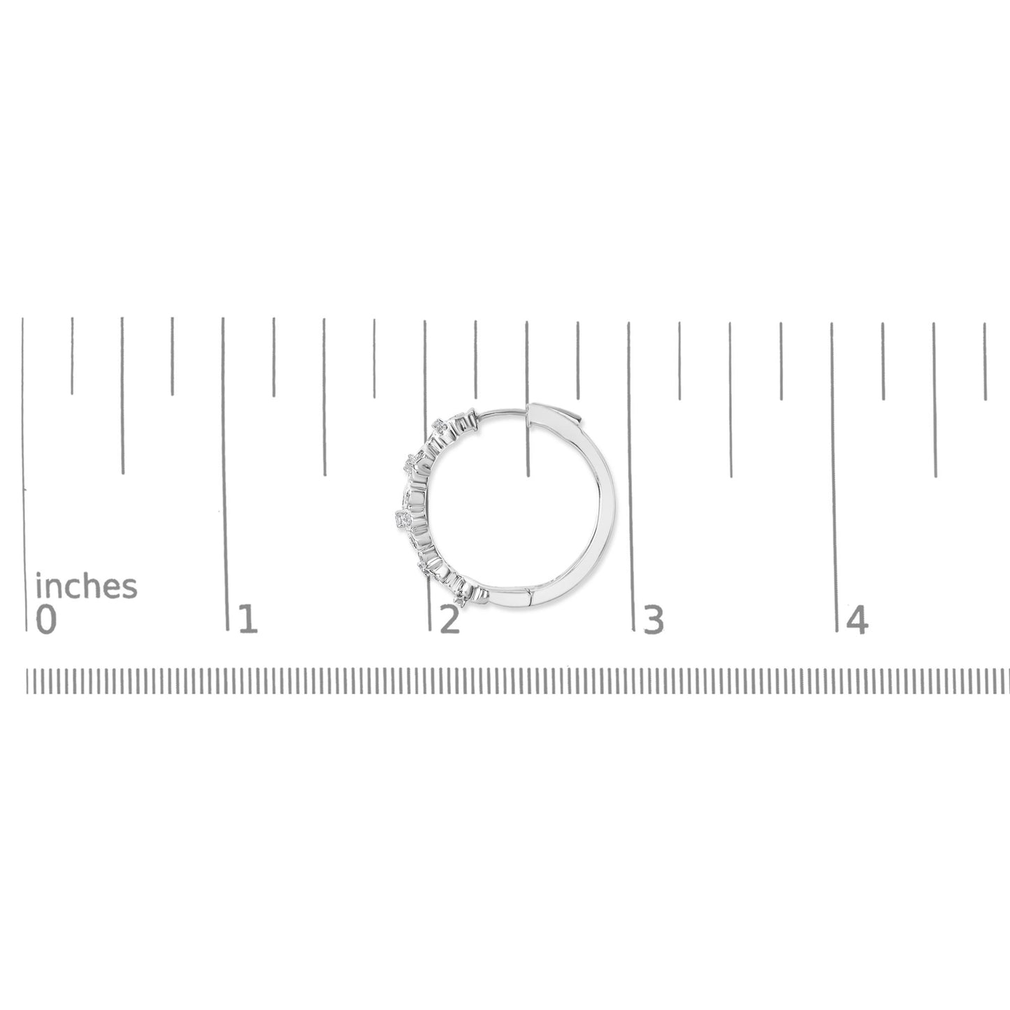 White circular hoop earring with round white gemstones in pave setting along half of the outer edge, shown flat on a scale from above.