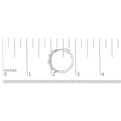 White circular hoop earring with round white gemstones in pave setting along half of the outer edge, shown flat on a scale from above.