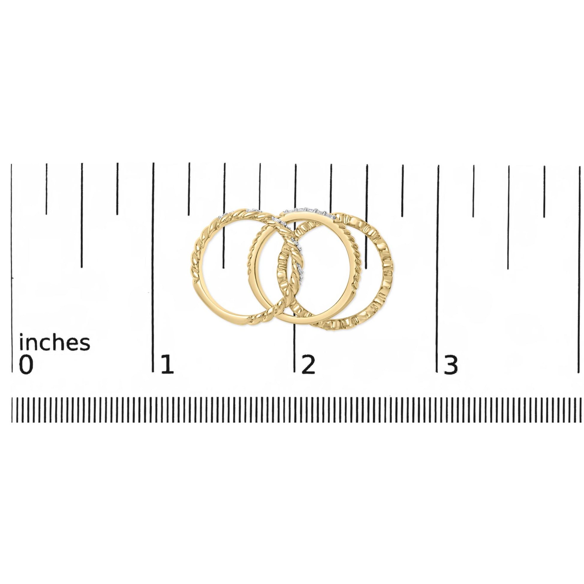 Three yellow and white metal rings, one with round white gemstones in pave setting, shown on a ruler scale from a top flat angle.
