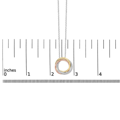 White metal necklace shown on a scale, front view, featuring a circular pendant with intertwined rings in three metal colors, one ring adorned with white round gemstones in shared prong settings.