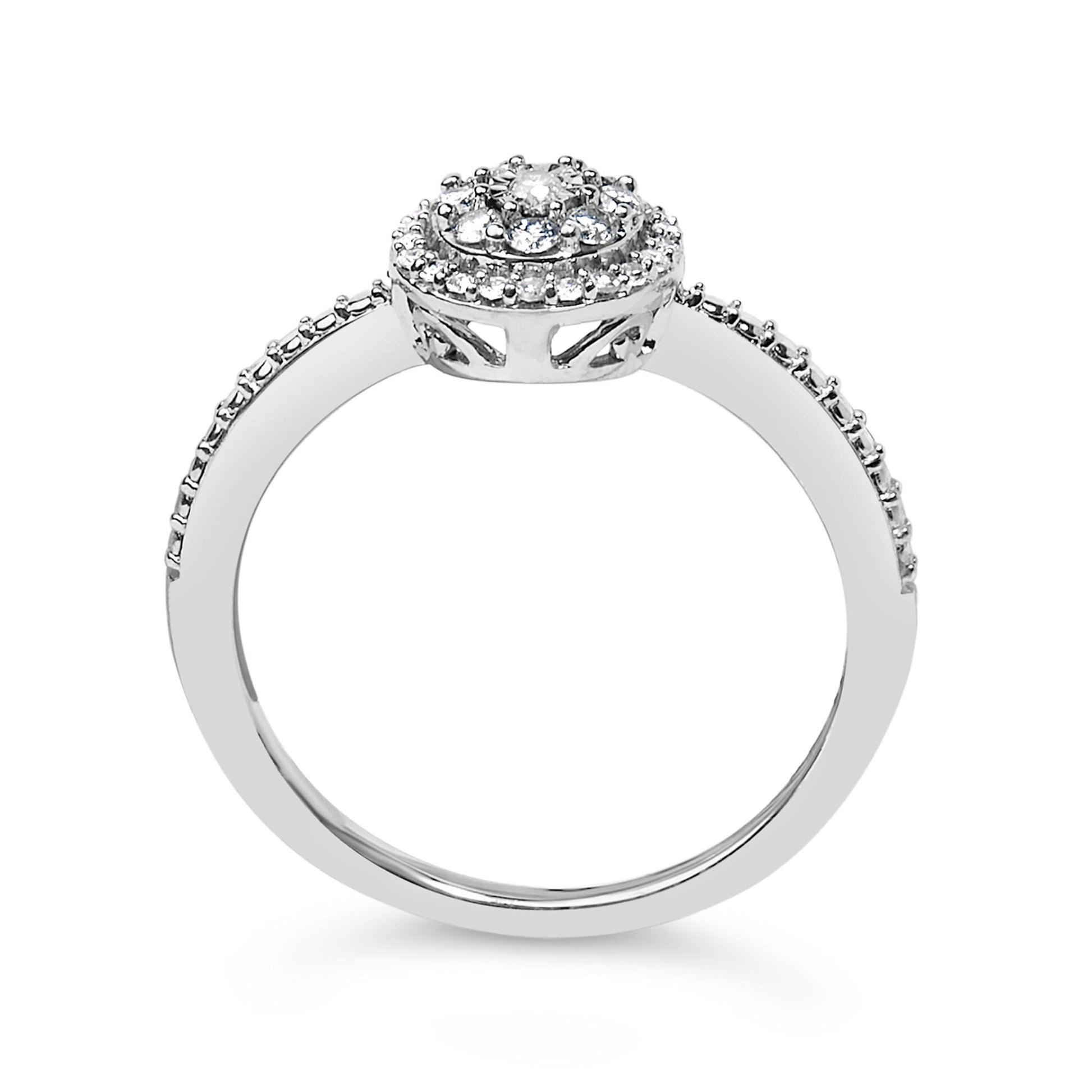 White metal ring with round white gemstones in prong settings on the band and a raised circular cluster, shown from a side angle.