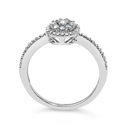 White metal ring with round white gemstones in prong settings on the band and a raised circular cluster, shown from a side angle.