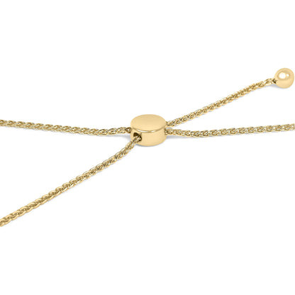 Close-up angled view of a yellow metal bracelet with woven chain detail and a smooth round slider clasp.