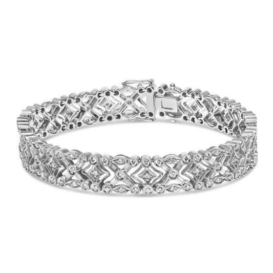White metal bracelet with intricate design featuring round bezel-set white gemstones and baguette channel-set white gemstones, shown from a front angled view.