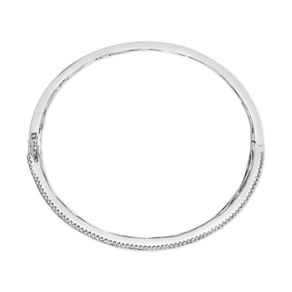Top-down view of a white metal bracelet with round white gemstones set along one side and a clasp on the left side.
