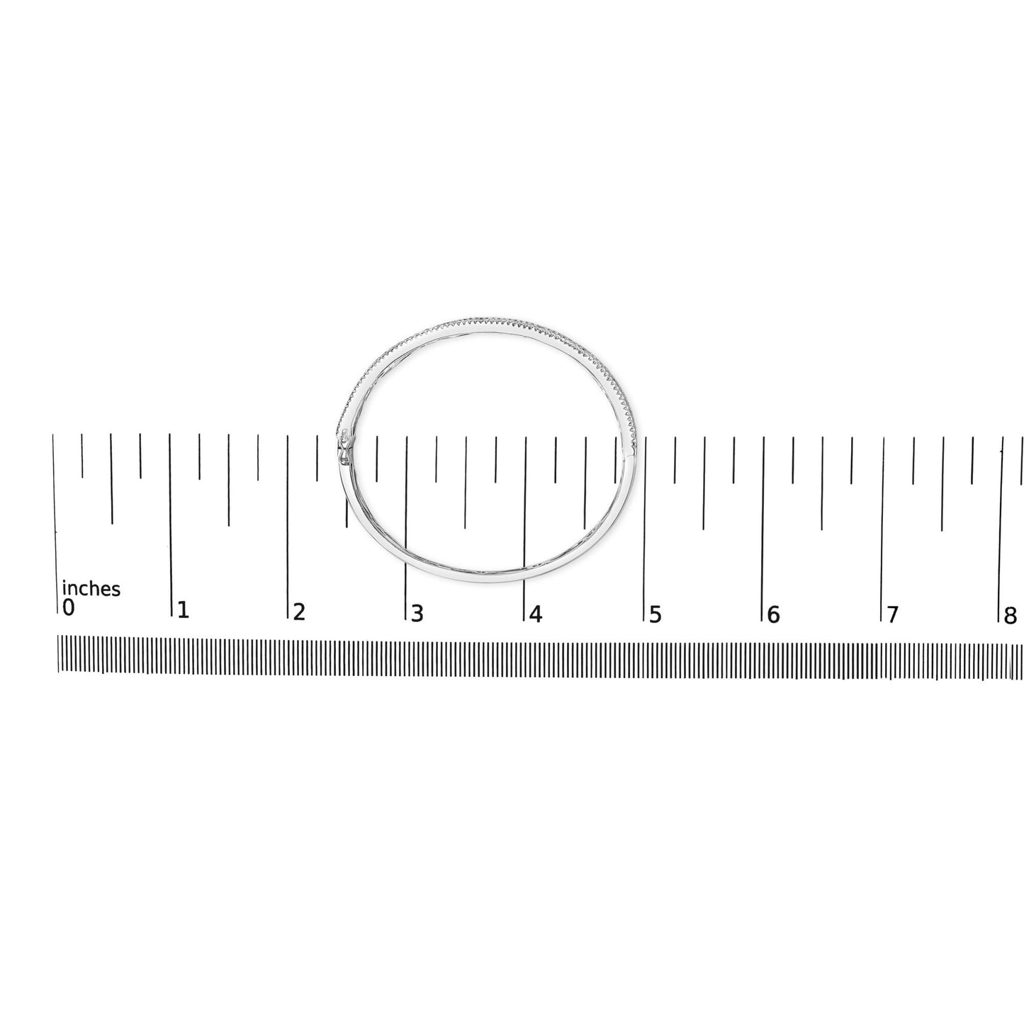 Top-down view of a white metal bracelet with round white gemstones in prong settings and blue square-shaped gemstones in channel settings, placed on a ruler for size reference.