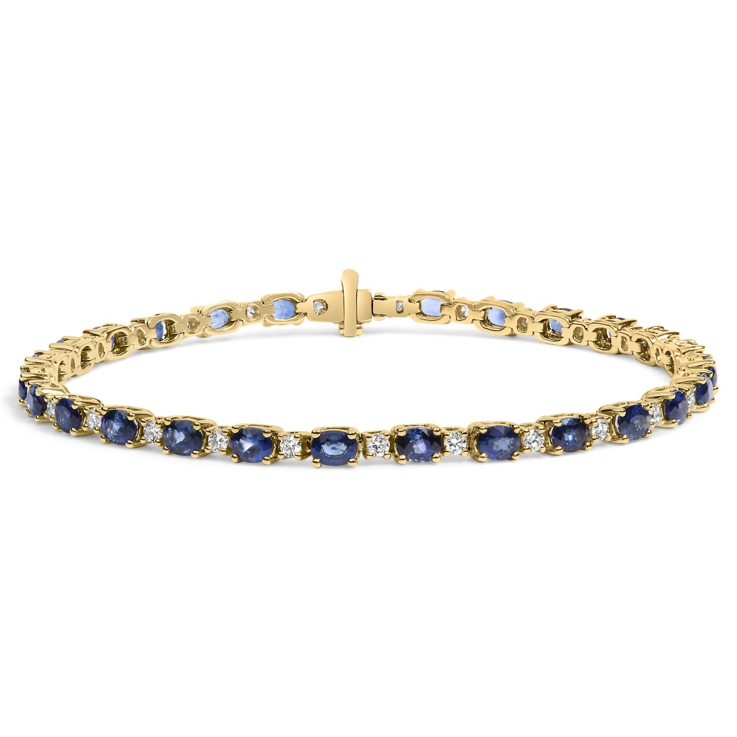 Yellow metal bracelet with alternating oval blue gemstones and round white gemstones in prong settings, shown in a close-up front angle.