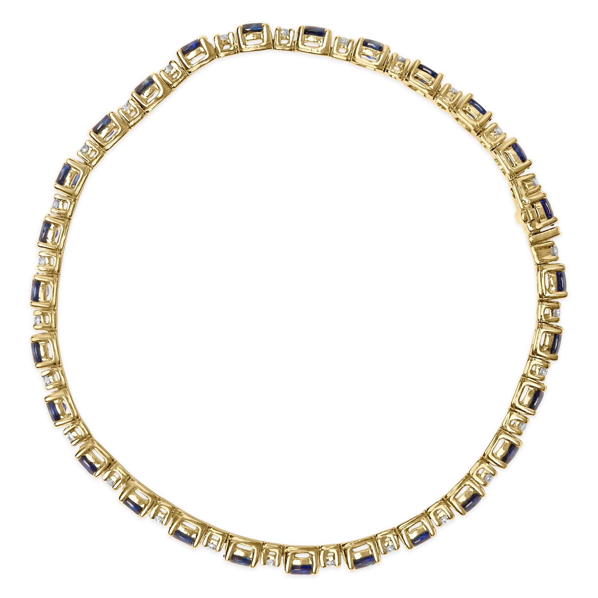 Top-down view of a yellow metal bracelet featuring alternating oval blue gemstones and round white gemstones, both in four-prong settings.