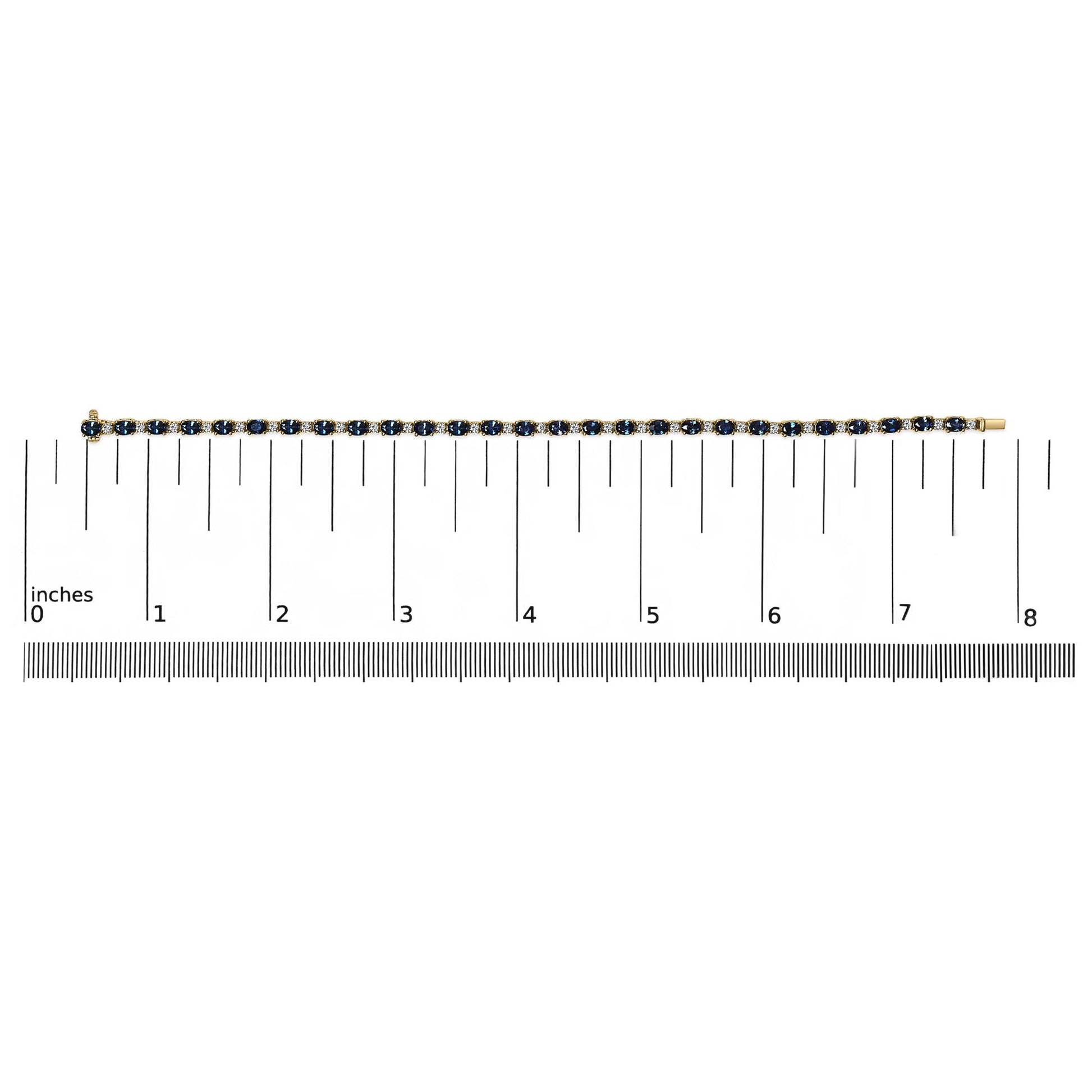 Yellow bracelet with alternating oval blue and round white gemstones in four-prong settings, displayed flat on a ruler for size reference, top-down angle.