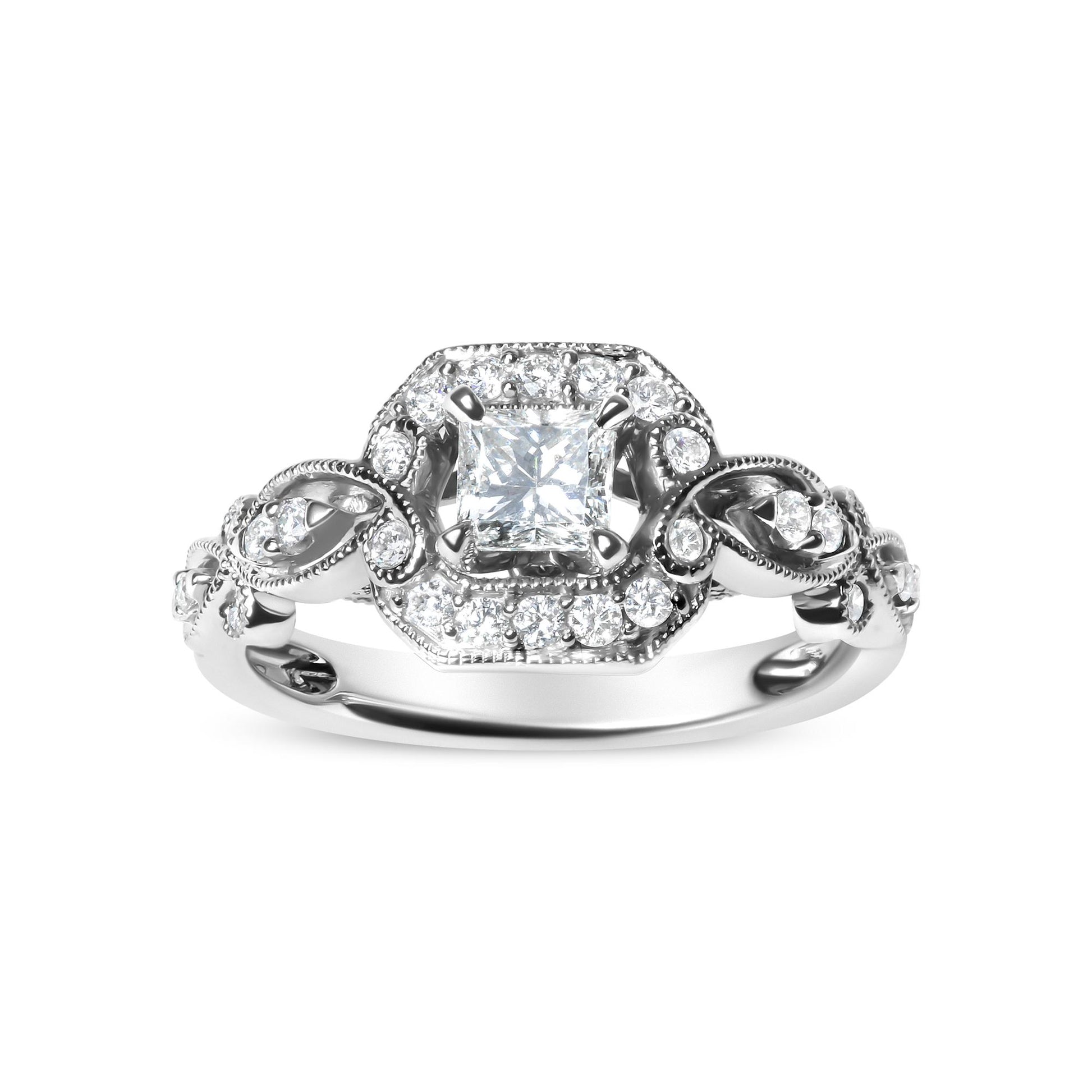 Front angle of white metal ring featuring a princess shape gemstone in a four-prong setting surrounded by round gemstones in a shared prong setting along the band.