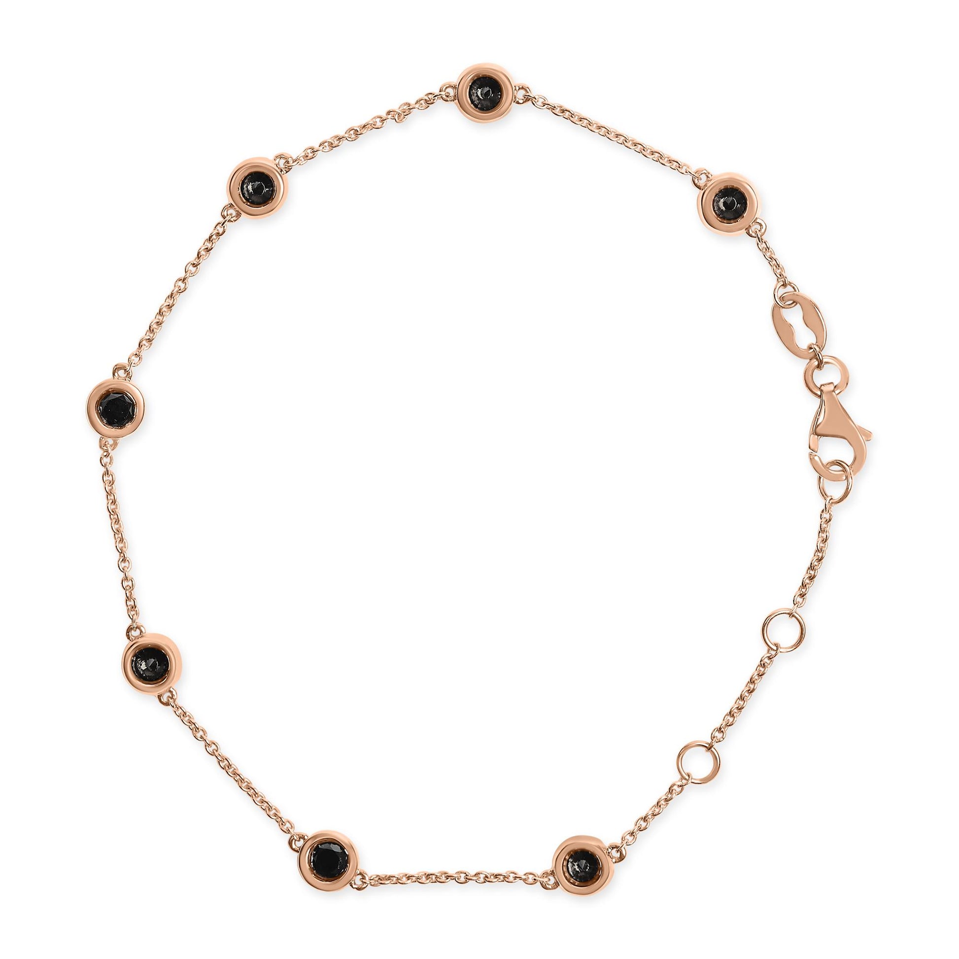Top-down view of a rose-colored bracelet with a delicate chain featuring round black gemstones in bezel settings evenly spaced along the chain, including a lobster clasp closure.