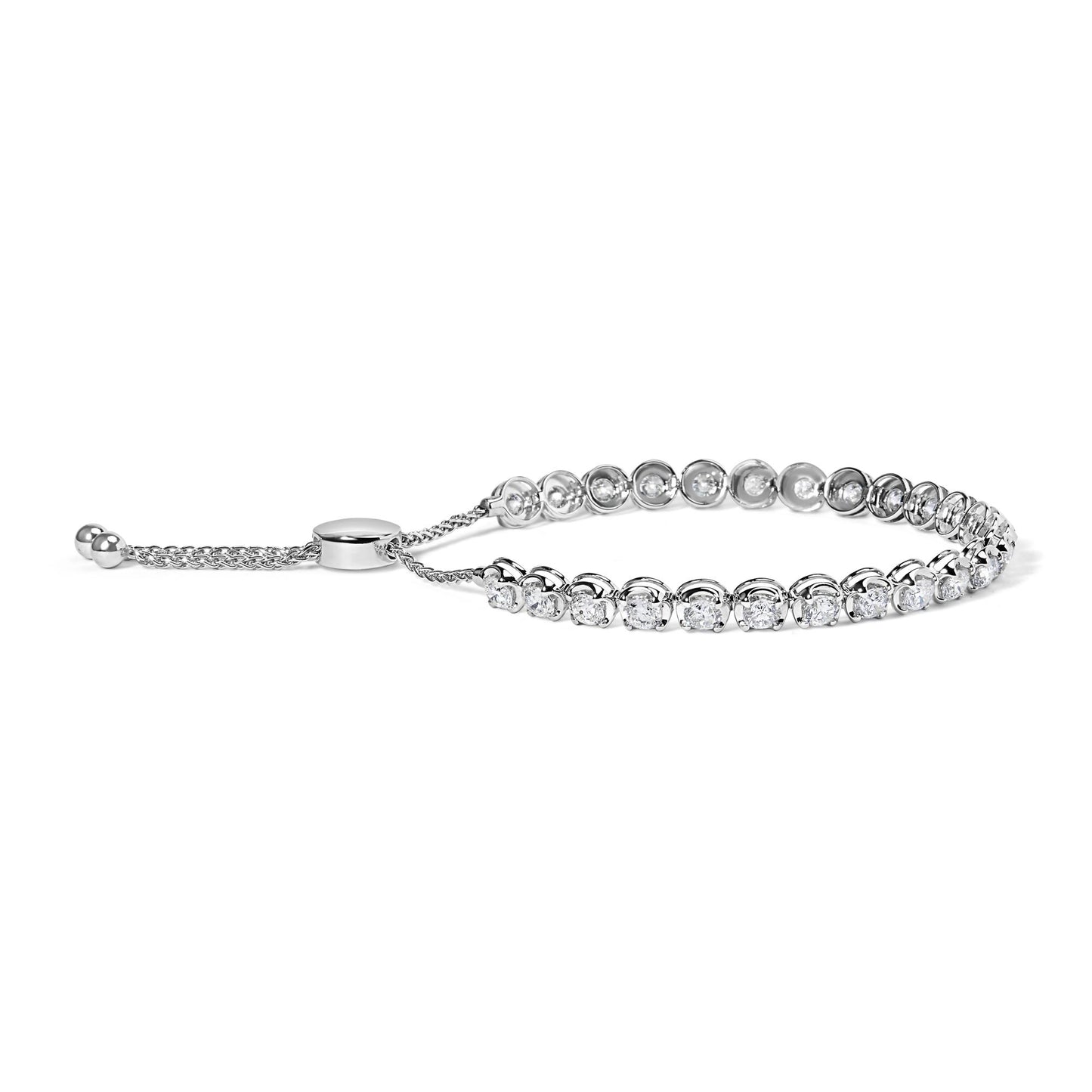 White metal bracelet with round white gemstones in 4-prong settings shown from a side angle.