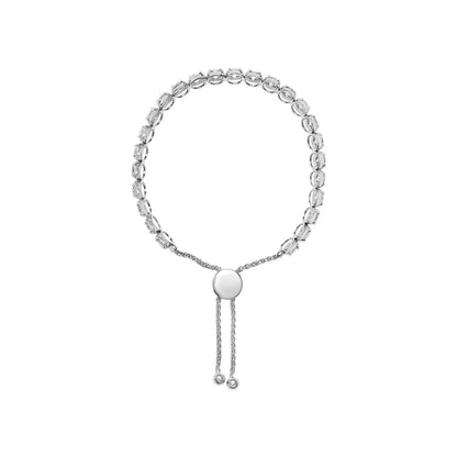 White metal bracelet with round white gemstones in 4-prong settings, viewed from the front with adjustable sliding closure and dangling chain ends.