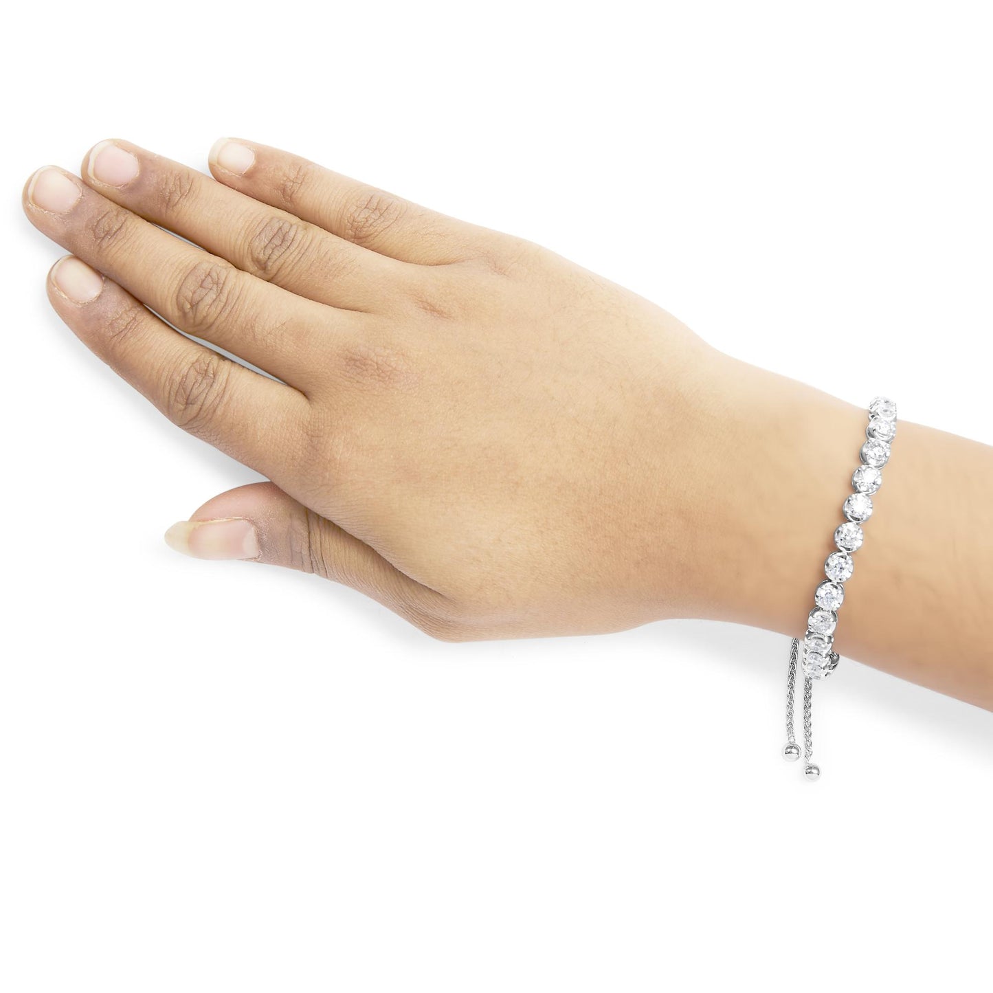 White metal bracelet with round white gemstones in 4-prong settings, shown on a model's wrist from a top angle.