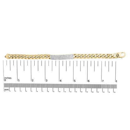 Top-down view of a yellow metal bracelet with a central section paved with white round gemstones, displayed on a ruler for size reference.