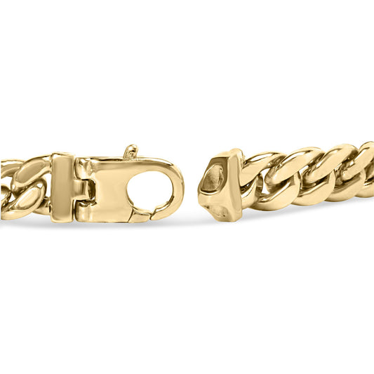 Close-up front angle of a yellow metal bracelet clasp with chain links.