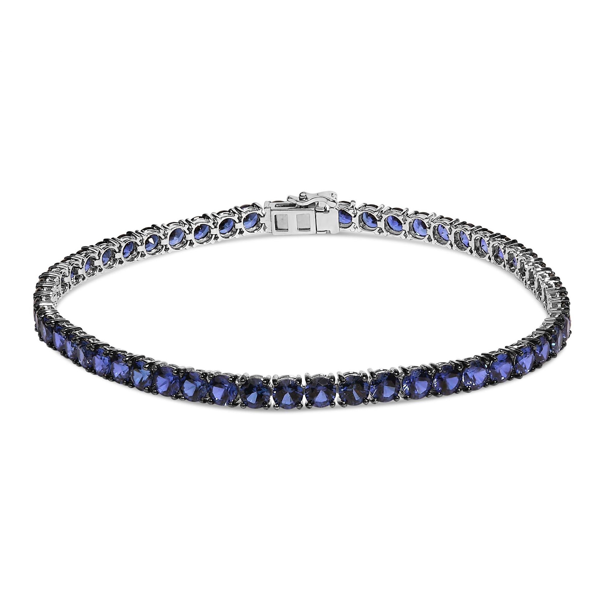 White metal bracelet with round blue gemstones set in 4-prong settings, shown from a front angle on a white background.