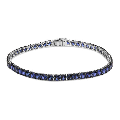 White metal bracelet with round blue gemstones set in 4-prong settings, shown from a front angle on a white background.