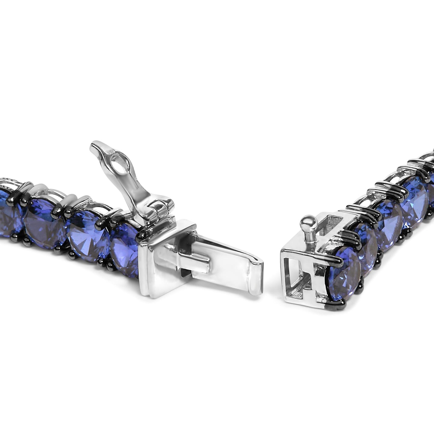 Close-up front angle of a white metal bracelet with round blue gemstones in 4-prong settings, shown open.