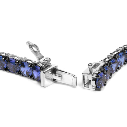 Close-up front angle of a white metal bracelet with round blue gemstones in 4-prong settings, shown open.