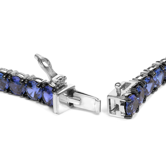 Close-up front angle of a white metal bracelet with round blue gemstones in 4-prong settings, shown open.