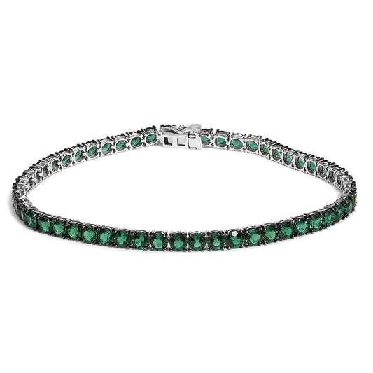 White bracelet with round green gemstones in a 4-prong setting, shown from a front angle on a white background.