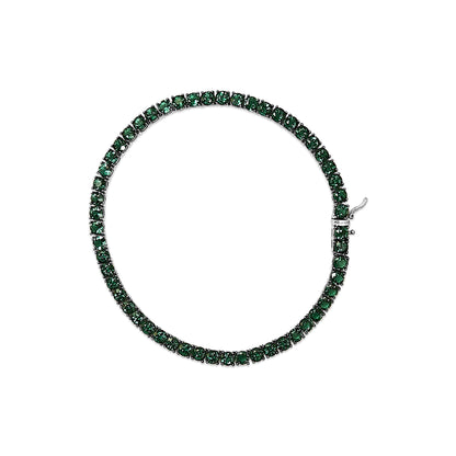 Top-down view of a white bracelet set with round green gemstones in a continuous line with a clasp visible.