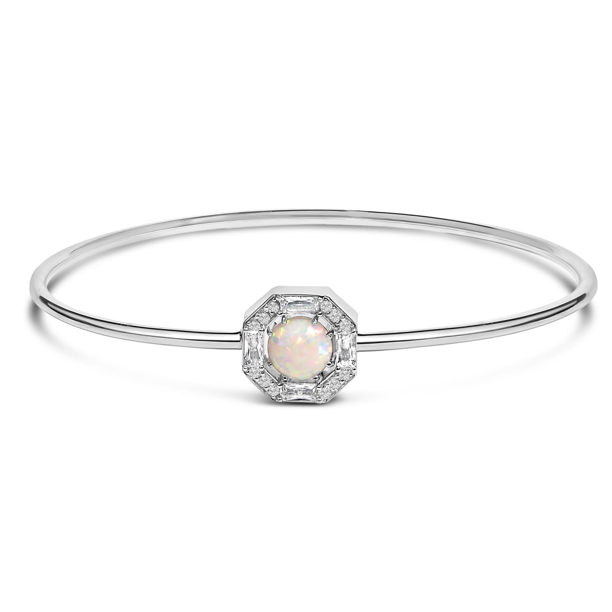 White metal bracelet with a thin circular band, centered with a round white opal gemstone surrounded by white round and baguette-shaped gemstones in prong settings, shown in a front-facing view on a white background.