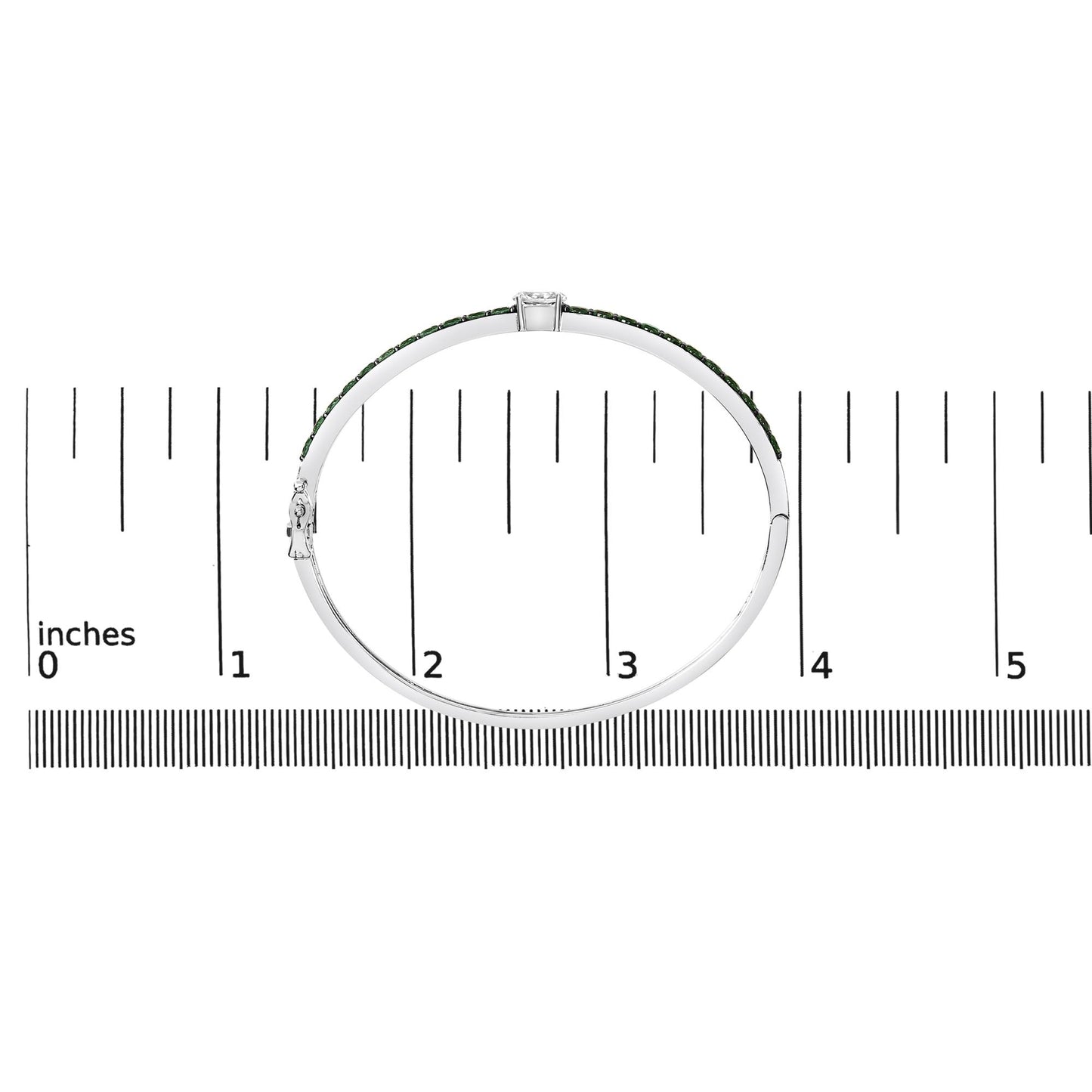 White metal bracelet with a row of round green gemstones and one oval white gemstone in a prong setting, shown on a ruler scale from side angle.