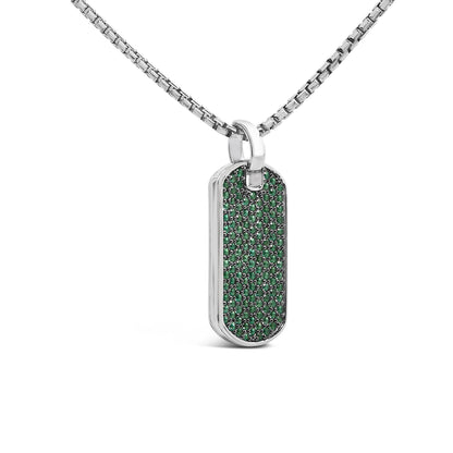 Close-up front angle of a white necklace with a rectangular pendant featuring multiple small round green gemstones set in a shared prong setting.