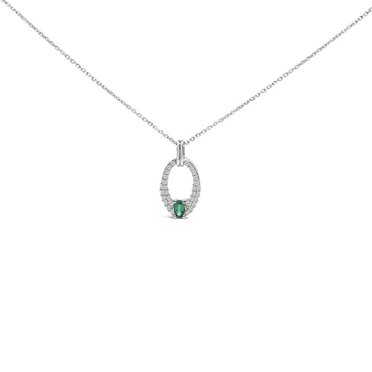 White metal necklace with an oval-shaped pendant shown from the front on a white background. The pendant features a green oval gemstone at the bottom center, surrounded by multiple small white round gemstones in a prong setting.