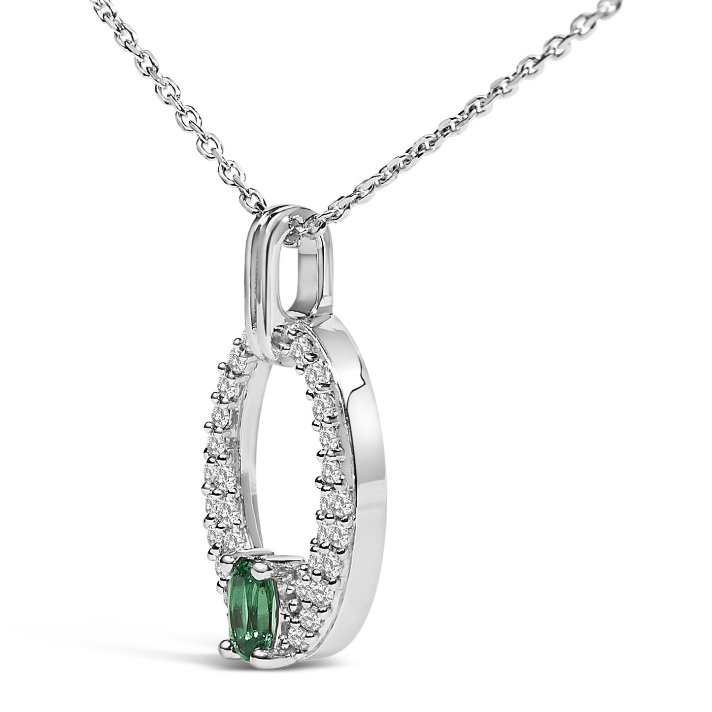 Close-up angled view of a white metal necklace pendant featuring an oval-shaped green gemstone at the bottom center, surrounded by a loop of small round white gemstones, all set with prongs, shown on a white chain.