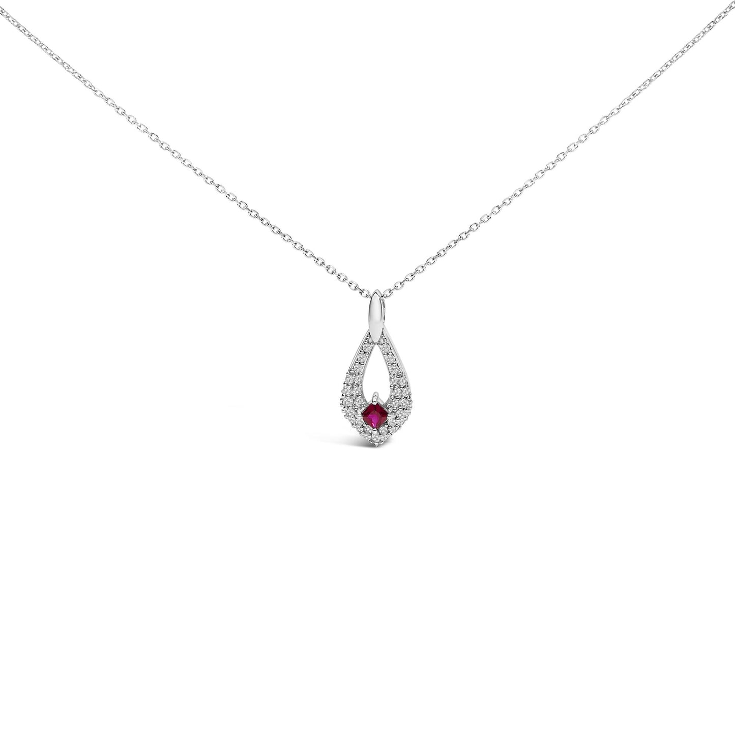 Front view of a white metal necklace with a teardrop-shaped pendant featuring a square red gemstone at the center surrounded by small round white gemstones, all set in prongs.