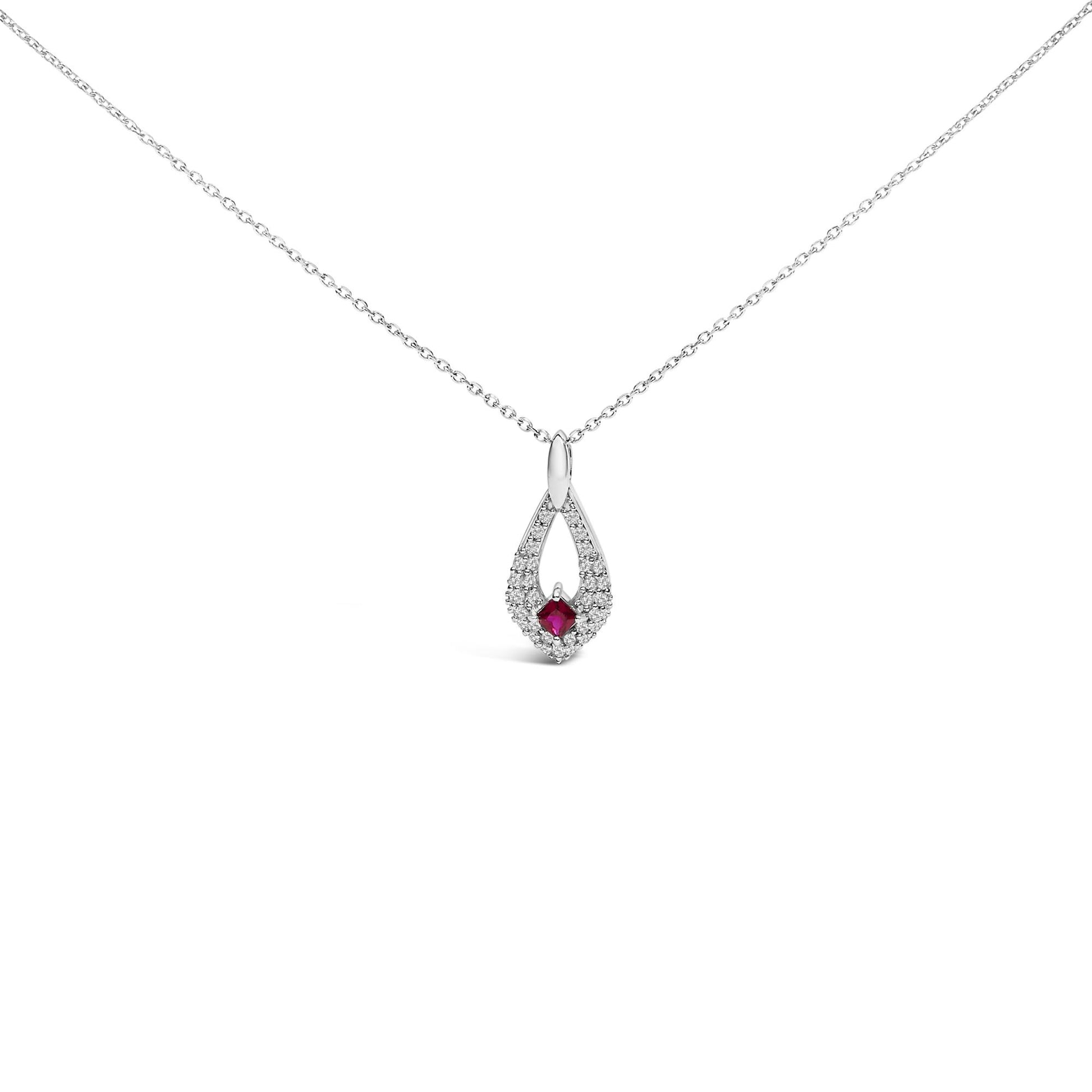 Front view of a white metal necklace with a teardrop-shaped pendant featuring a square red gemstone at the center surrounded by small round white gemstones, all set in prongs.