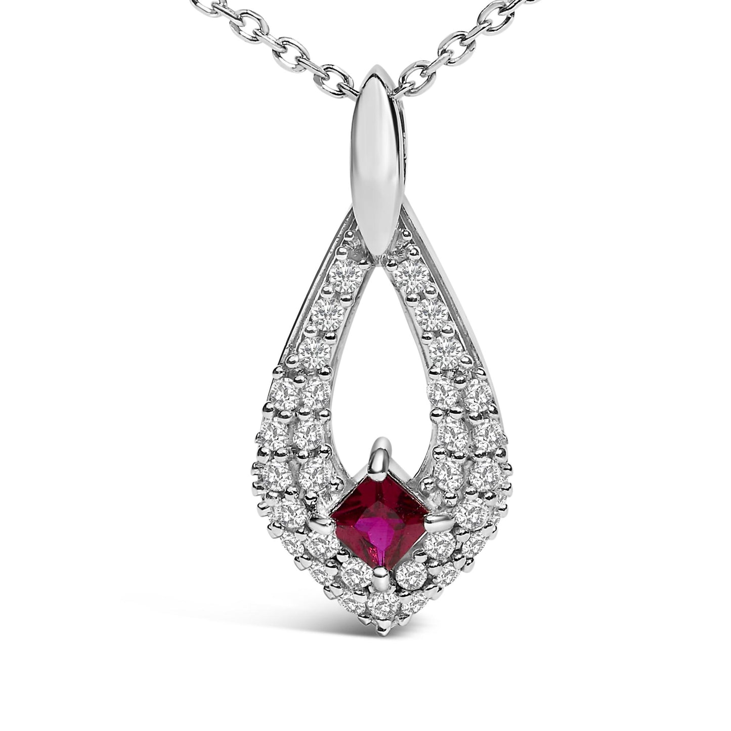 Close-up front view of a white metal necklace pendant with a teardrop shape featuring a princess-cut red gemstone in the center surrounded by multiple round white gemstones, shown on a white background.