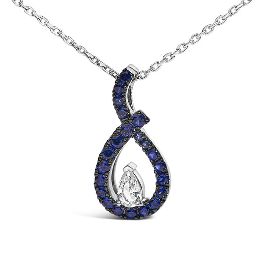 Close-up front view of a white metal necklace pendant with an open teardrop shape, featuring a pear-shaped white gemstone at the center surrounded by round blue gemstones in a prong setting.