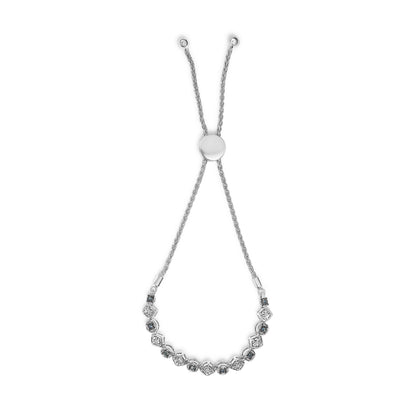 White metal bracelet with alternating white and blue round gemstones in two shapes, shown from above with adjustable sliding chain ends.