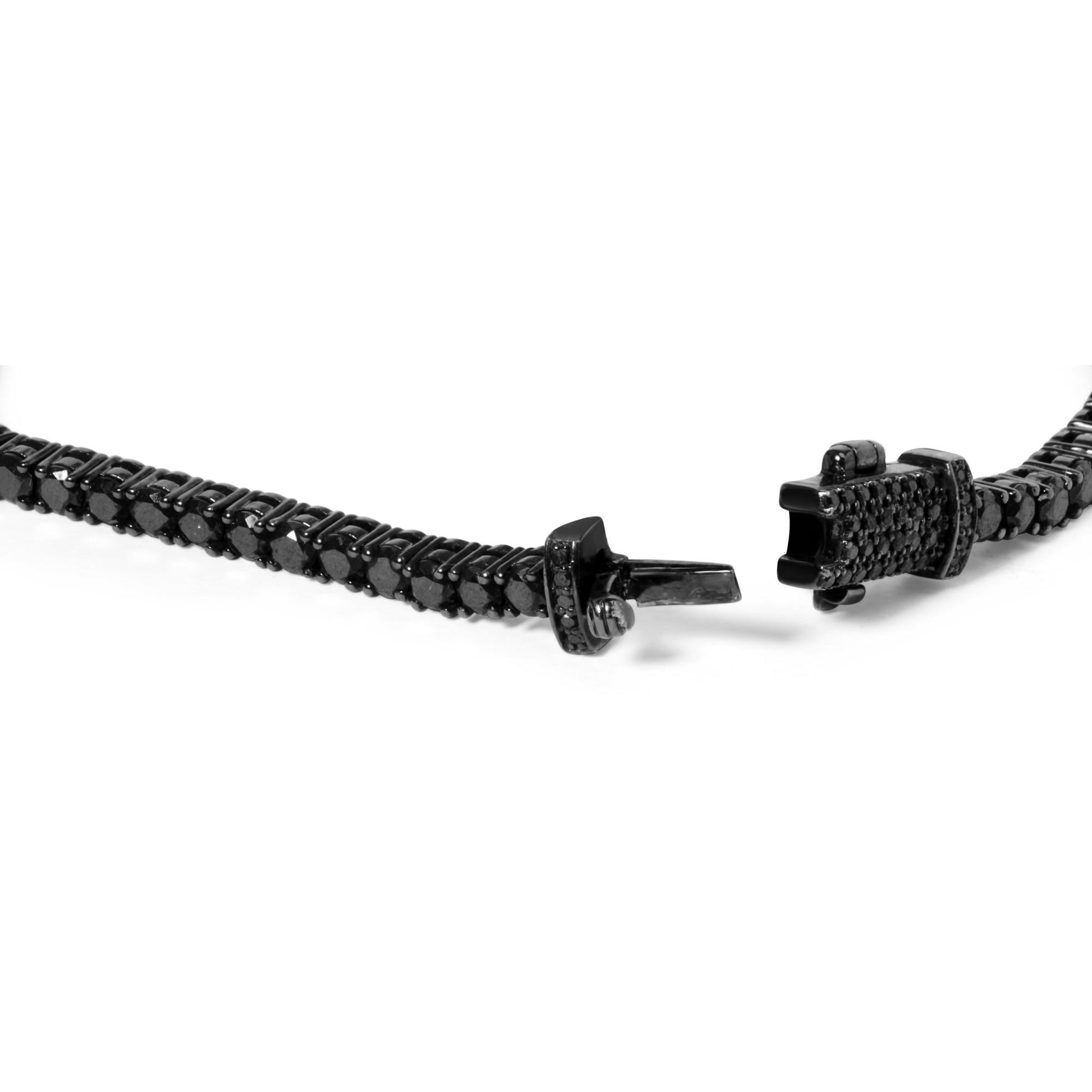 Close-up front angle of a white metal bracelet with multiple round black gemstones in various prong settings, showing the open clasp.