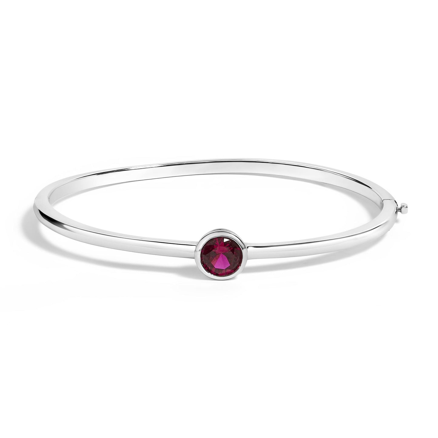 White bracelet with a round red gemstone in a bezel setting, shown in a side angled view on a white background.