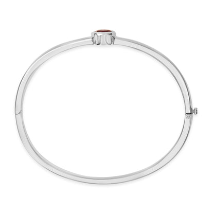 Top-down view of a white metal bracelet with a single round red gemstone in a bezel setting at the center.