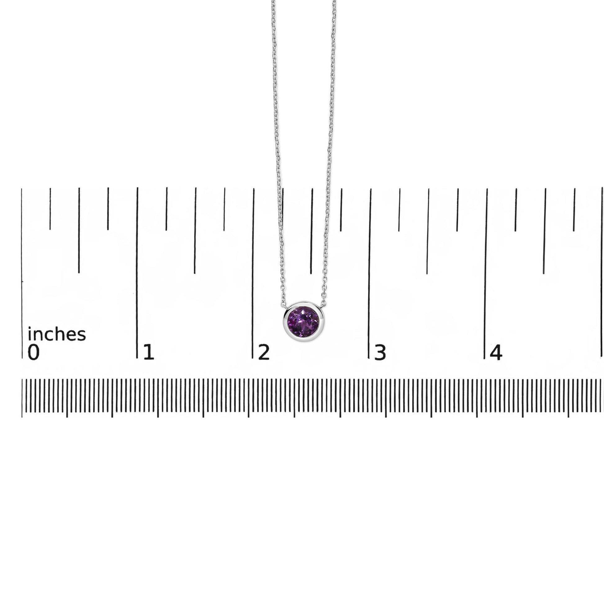 White necklace with a round purple gemstone in a bezel setting, shown front-facing on a scale.
